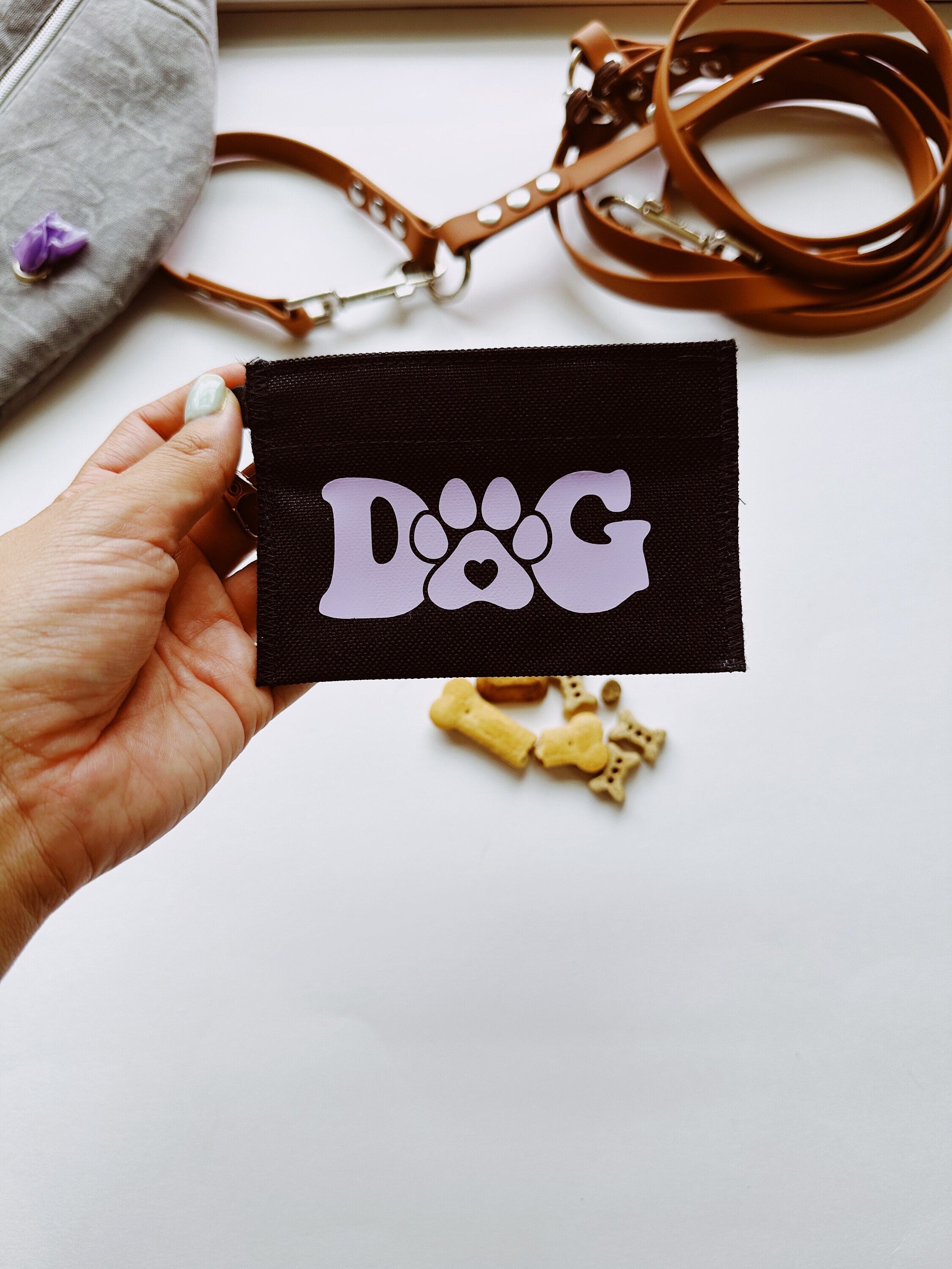 Small treat pouch that reads dog with a paw 