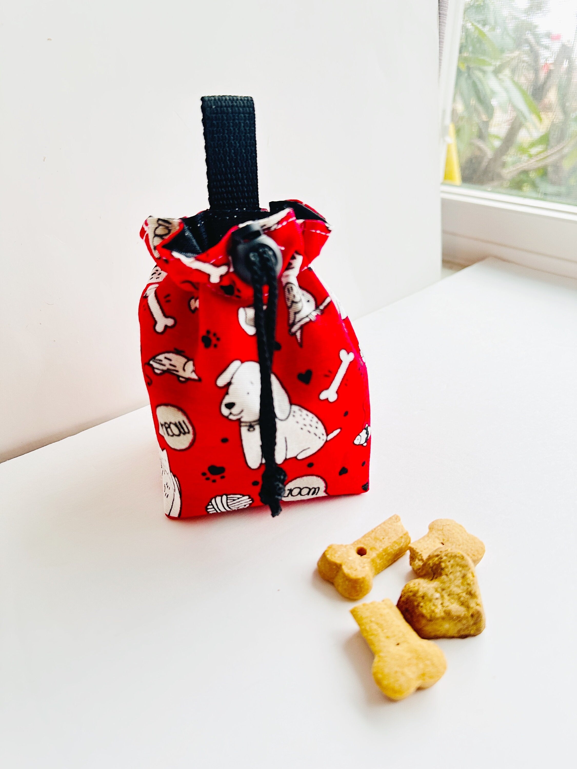 Red training pouch with many animals  